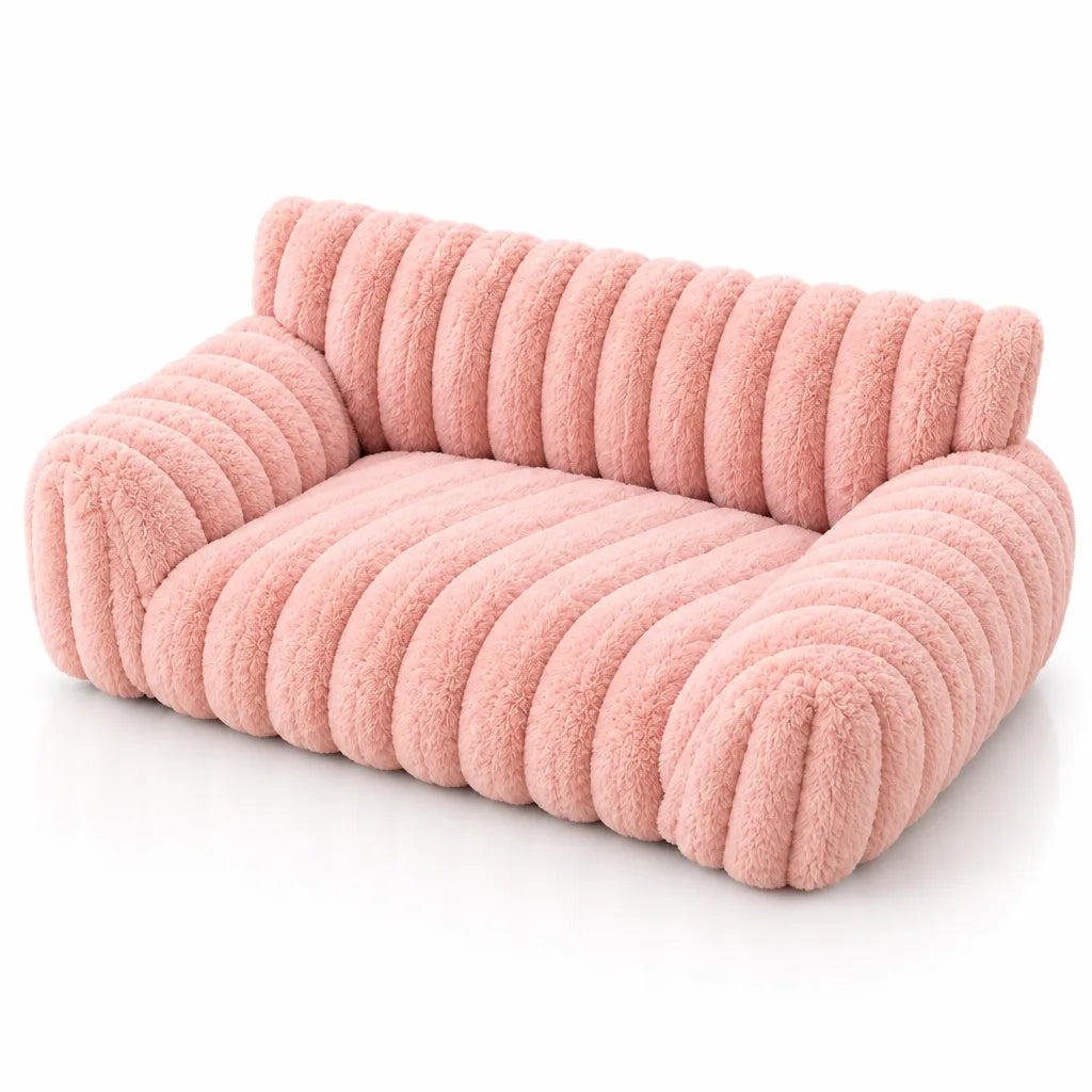 Pink plush pet bed shaped like a small sofa, with thick ribbed fleece channels across the backrest, seat and rounded arms, shown at an angle against a plain white background.