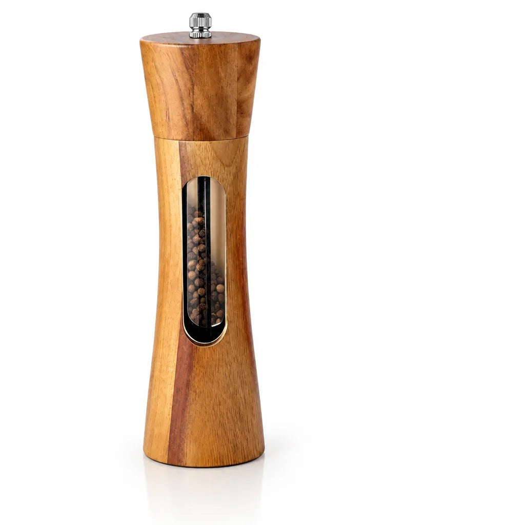 Tall hourglass-shaped wooden salt and pepper grinder standing upright on a white background, with a small metal adjustment knob on top and an oval window showing the whole peppercorns inside.