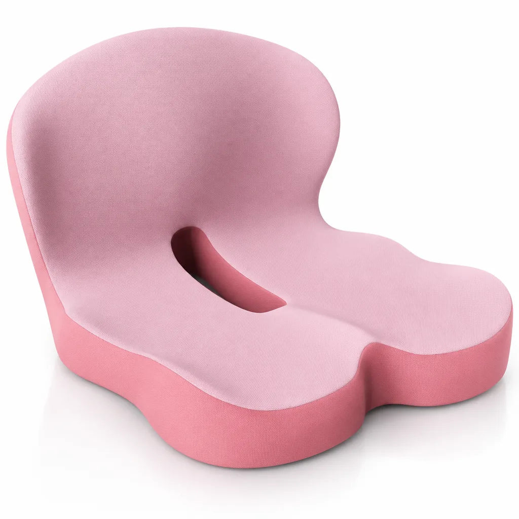 Pink memory foam seat cushion with a contoured backrest, cut-out opening in the middle and a darker pink base, shown at an angle against a white background.