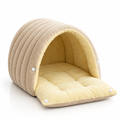 A beige corduroy 2-in-1 cat and dog cave bed with an arched dome roof, shown from the front on a white background with its quilted pale yellow plush mat extending out and fastened with white snap buttons.