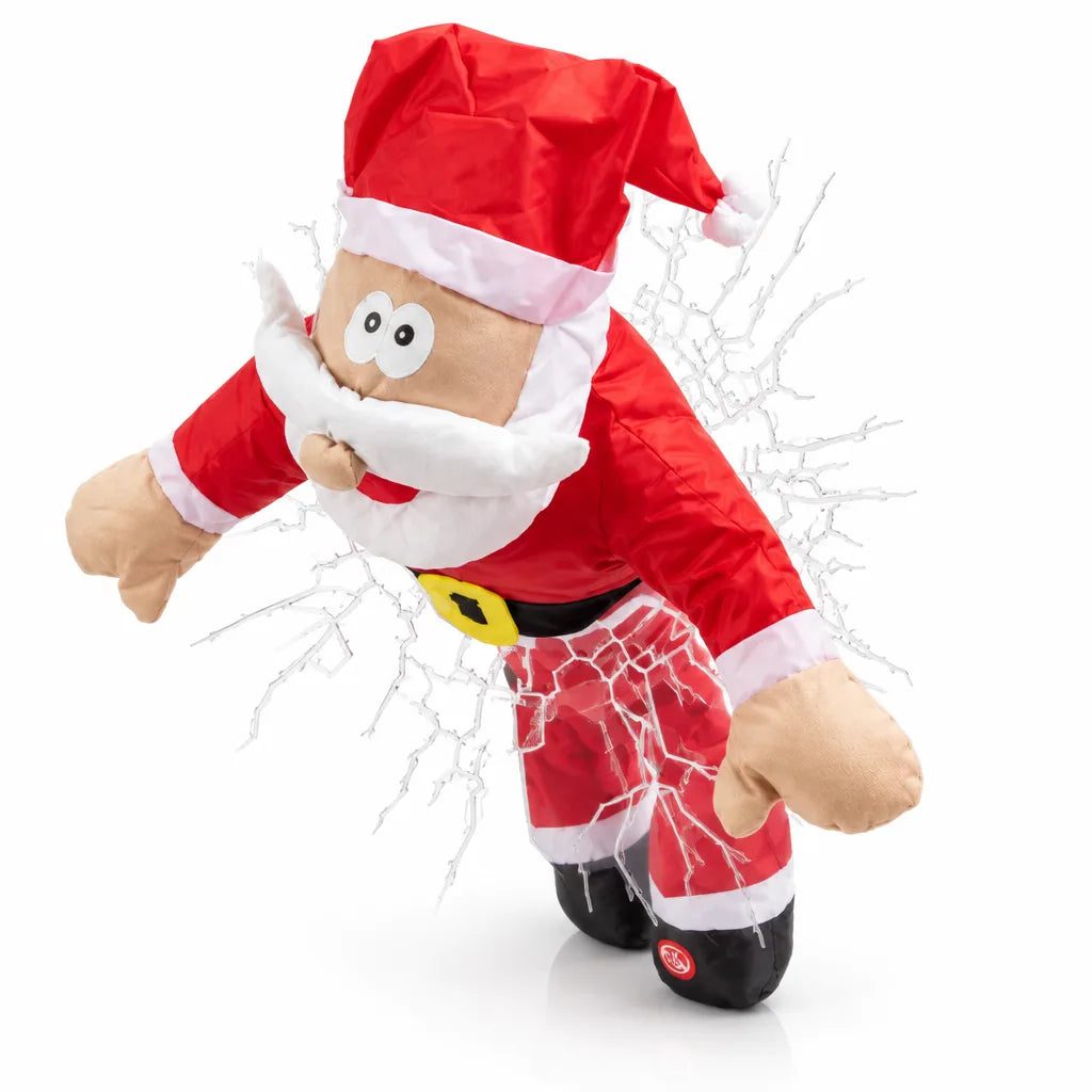 ChristmasCrash window decoration shaped like a plush Santa with wide cartoon eyes crashing head-first through a starburst of white cracked glass, arms outstretched and black boots trailing behind, shown against a plain white background.