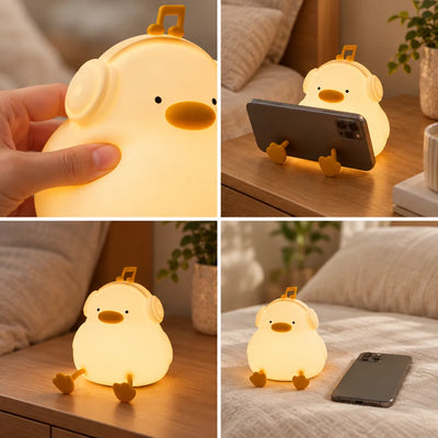 Four-panel grid showing a glowing Duck Night Light with headphones and a music-note handle: a hand pressing its soft silicone head, the duck's feet propping up a phone on a wooden table, the lamp sitting alone on the table beside a pillow and potted plant, and the lamp glowing on a bed next to a phone.