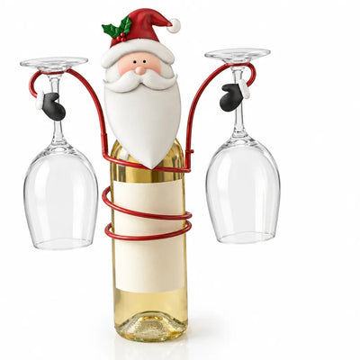Santa Claus bottle holder made of metal, its red wire frame coiled around a bottle of white wine with two empty wine glasses hanging upside down on either side.
