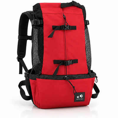 Red dog carrier backpack shown at an angle against a white background, with padded black shoulder straps, waist belt, mesh side panels for airflow, two black buckle straps across the front and a small paw-print brand tag.