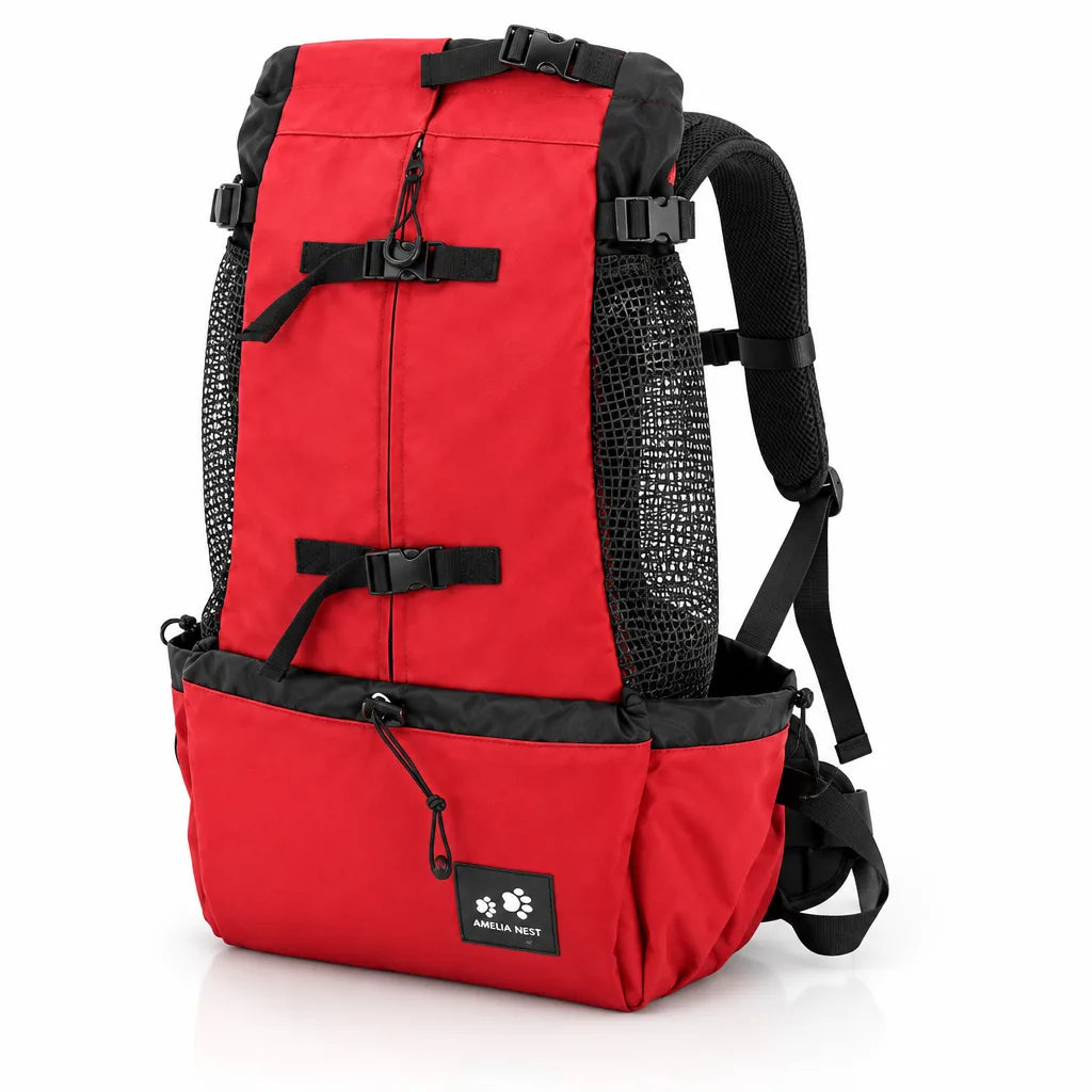 Red and black dog carrier backpack shown from a front three-quarter angle against a white background, with black mesh side panels, two adjustable buckle straps down the front, padded shoulder straps and waist belt, a lower pocket with a drawstring toggle, and a small Amelia Nest paw-print label.