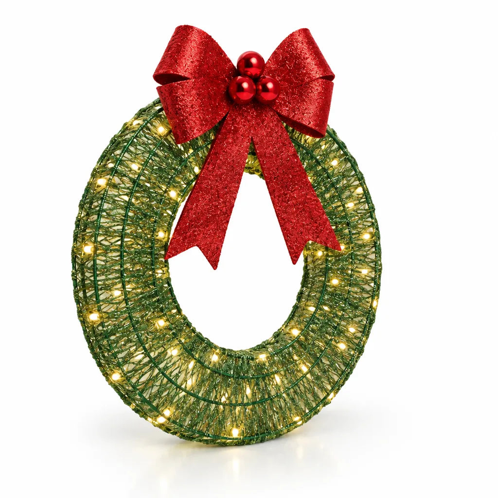 A 50 cm LED Christmas wreath lit with warm white bulbs, wound in green and gold thread over a wire frame and topped with a glittery red bow and red berries.