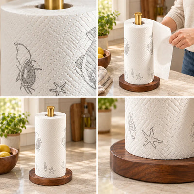 Four-panel grid showing the walnut paper towel holder on a kitchen counter: close-ups of the white roll embossed with crab, fish and starfish motifs, a hand tearing off a sheet, and the full holder with its brass post and round dark wood base beside a bowl of lemons and a potted herb.