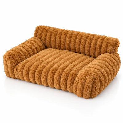 Khaki plush pet bed shaped like a small sofa, with thick ribbed faux-fur channels across the seat, backrest and rolled arms, shown at an angle on a white background.