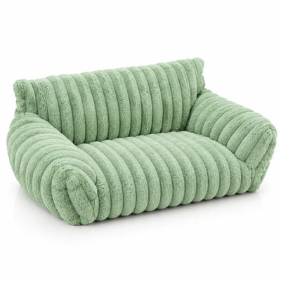 Sage green plush pet bed shaped like a small two-seater sofa, with thick ribbed faux-fur channels across the backrest, seat and rolled arms, shown alone against a plain white background.