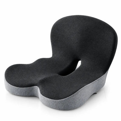 Dark gray memory foam seat cushion with a contoured backrest, scooped sides and a cut-out coccyx channel, shown at an angle on a white background with a lighter gray base visible underneath.