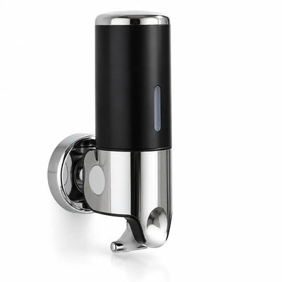 Black and chrome wall-mounted soap dispenser with a round mounting plate, a narrow level window on the cylinder and a push lever underneath, shown against a plain white background.